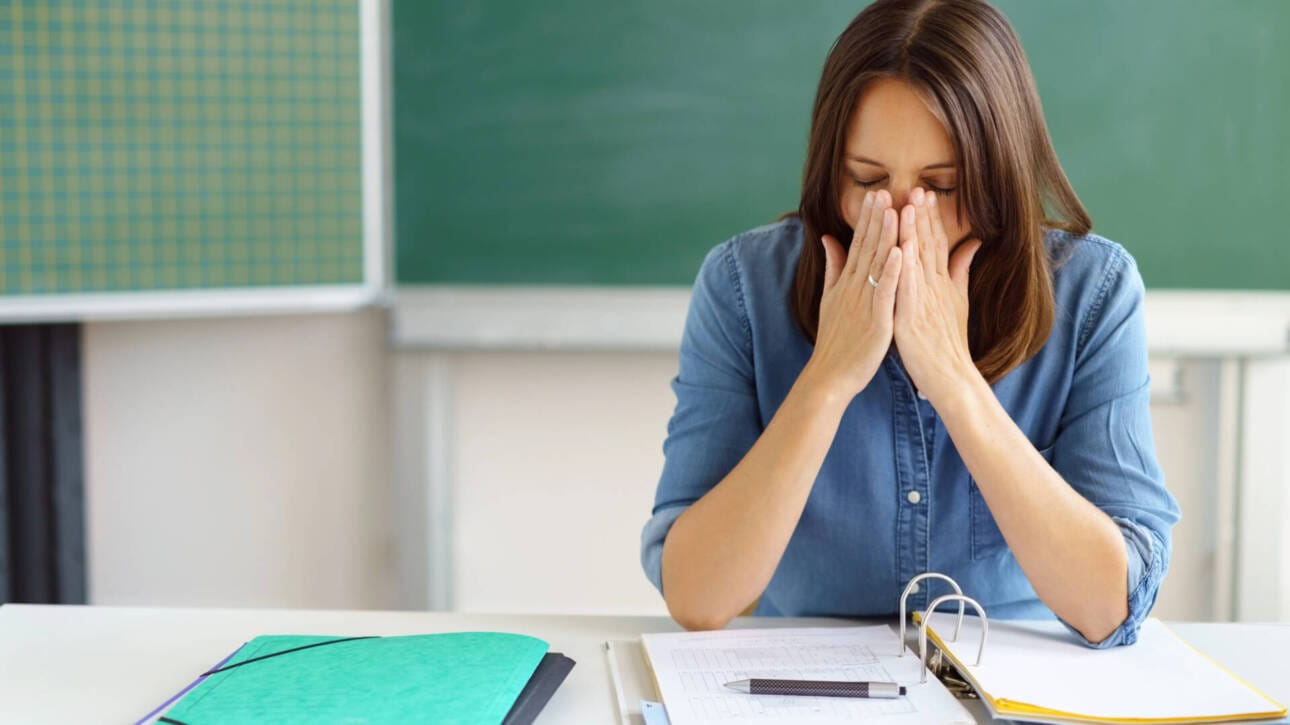 Lehrerin erschöpft am Pult